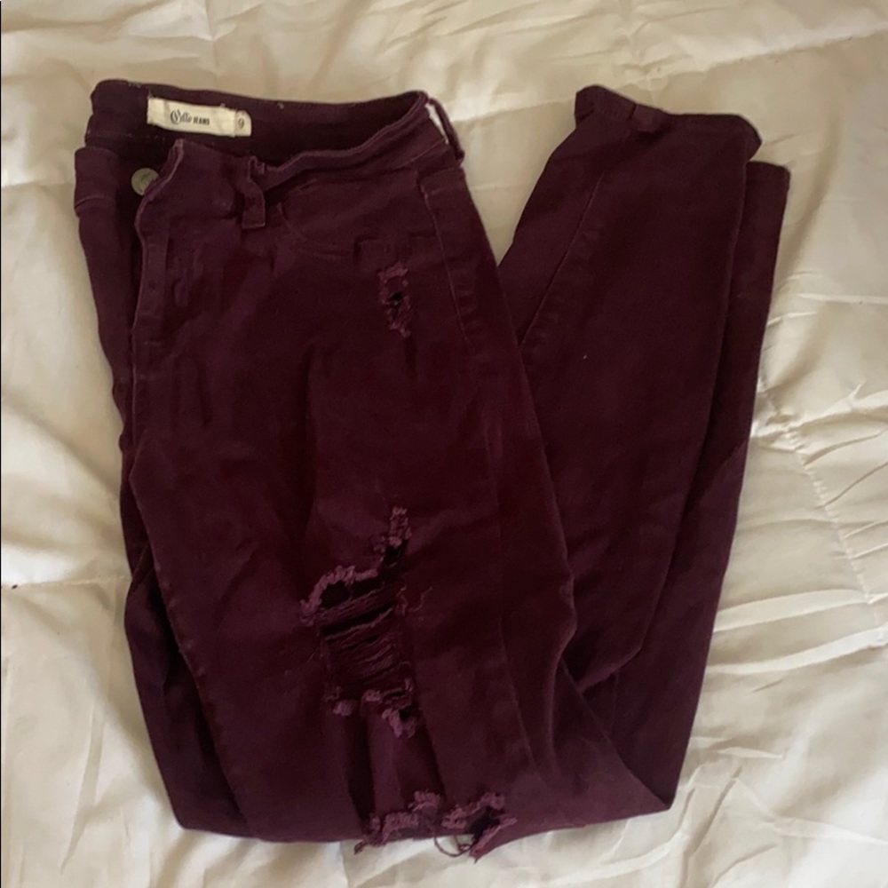 Distressed skinny jeans in burgundy